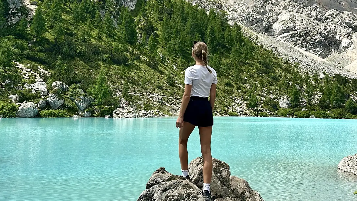 Turquoise-blue lake Lago di Sorapis in the middle of the Dolomites.